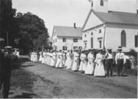 Women marching in parade, in front of Williamsville church