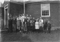Portrait of students and teachers in front of the Brookline Round Schoolhouse