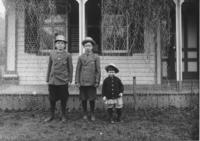 Three children in front of a house, Newfane, Vt.