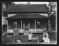 Family portrait in front of their dwelling with cat and dogs, Williamsville, Vt.