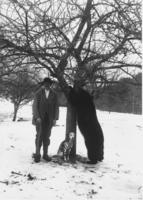 James Mundell standing next to a bear that he killed and a dog, Dover, Vt.