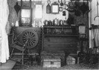 M.O. Howe's house interior with spinning wheel and trunks, Newfane, Vt.