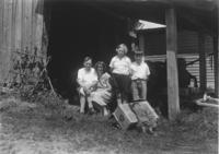 Family portrait in front of a barn with a porcupine skin
