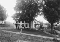 Farmhouse with people in front, either the Phillips, Cook or Pratt house