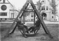 Frank Stevens and classmate on swing in front of Seminary, Townshend, Vt.