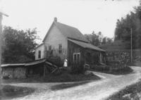 Unidentified house with woman holding a cat, Wardsboro, Vt.