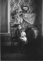 Young girl with doll inside house