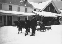 Frank and Grace Stratton with oxen and sled in snow, Williamsville, Vt.