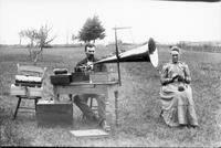 Couple with phonograph in a field