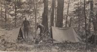 Men setting up tents and campsite