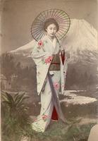 Woman with umbrella posing in front of a mural of Mt Fuji