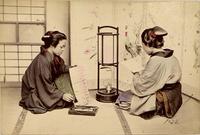 Two women practicing calligraphy