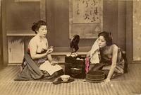 Two women bathing and dressing themselves