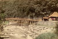 A bridge spanning a small river in the Japanese countryside