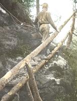 Lyman Burnham climbing the ladder on Burnt Rock Mountain