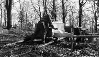 Worker pumping maple sap into pipeline
